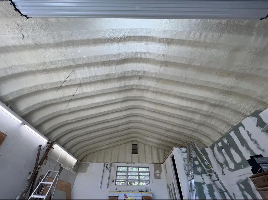 Spray polyurethane foam applied to the underside of a metal roof deck in Redan